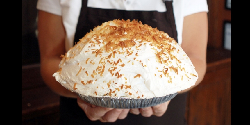 a chef holding a pie