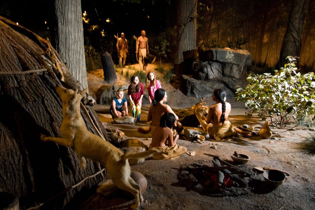 three kids at an exhibit at the Mashantucket Pequot museum in Connecticut